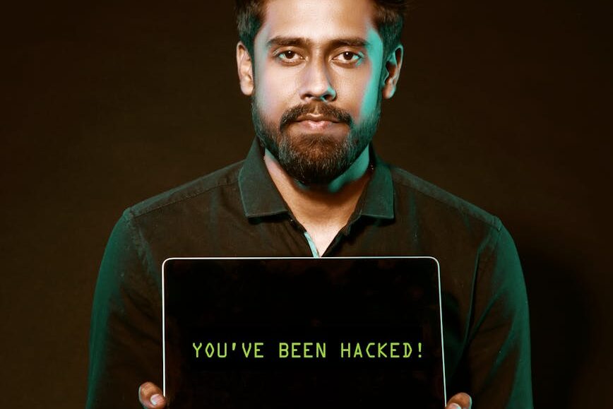 man holding laptop computer with both hands