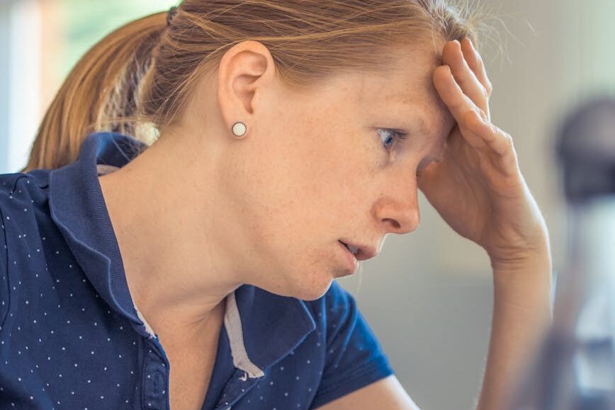 woman sitting in front of the laptop computer in shallow photo